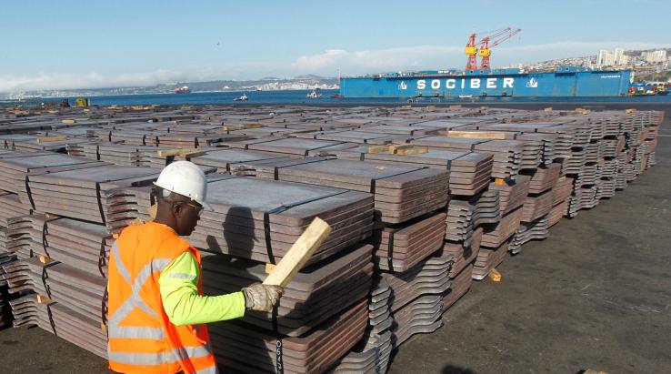 A port worker checks a shipment of copper that is to be exported to Asia, in Valparaiso port, northwest of Santiago, January 25, 2015.