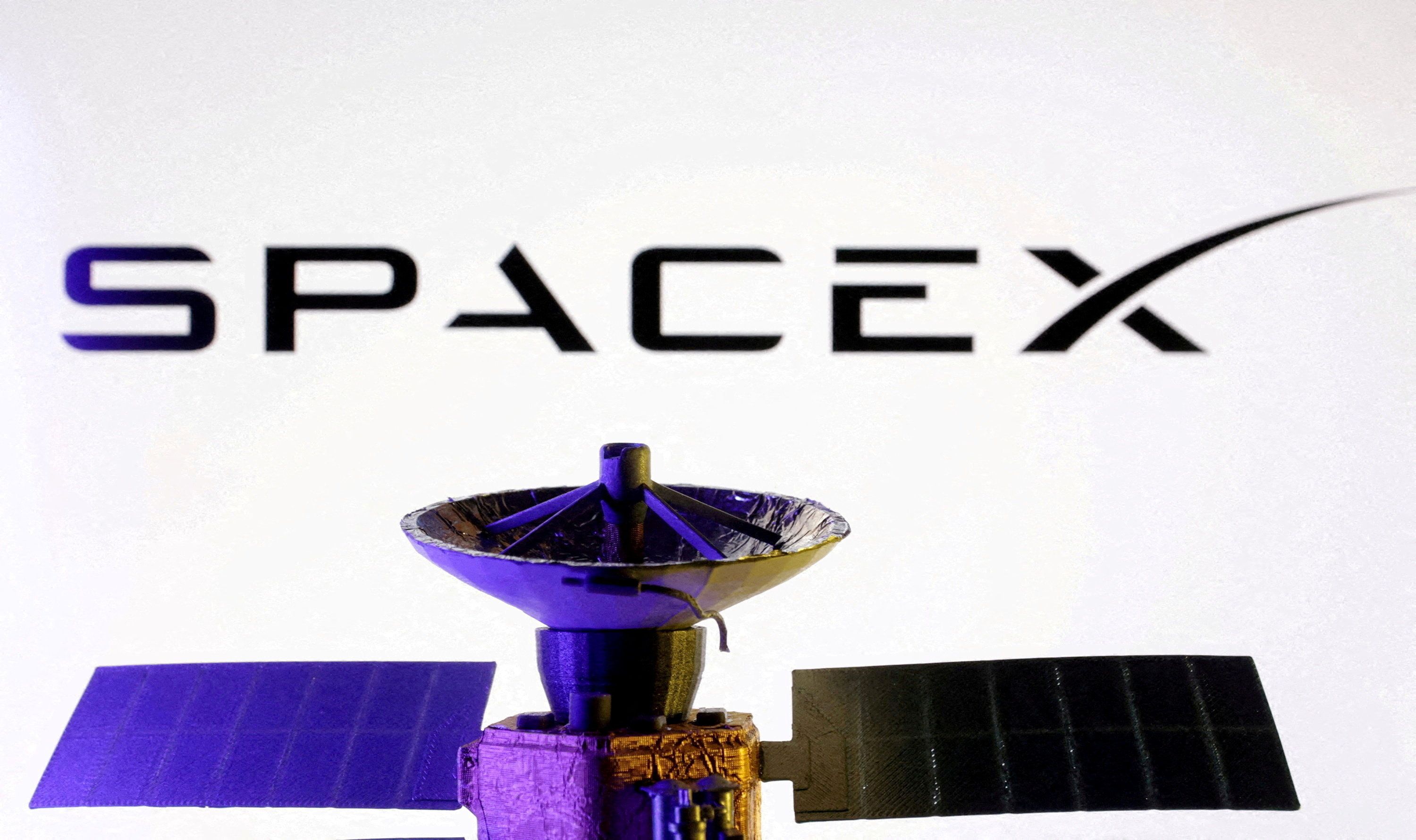 SpaceX logo and miniature satellite model.