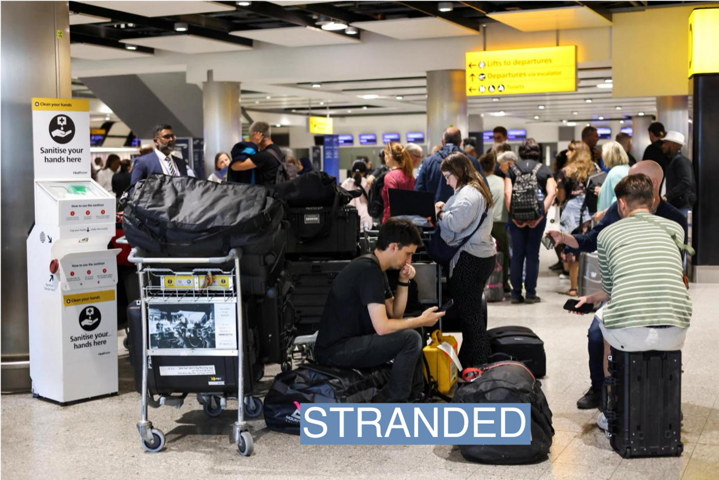 Travellers wait near the British Airways check-in area at Heathrow Airport, as Britain's National Air Traffic Service (NATS) restricts UK air traffic due to a technical issue causing delays, in London, Britain, August 28, 2023. REUTERS/Hollie Adams