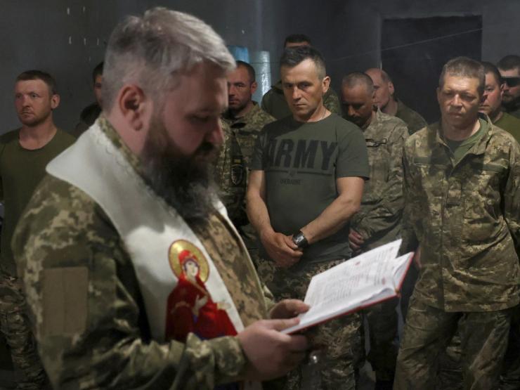 Military chaplain Oleksandr Karapetian conducts the Easter service for service members of the 93rd Kholodnyi Yar Separate Mechanized Brigade near a front line