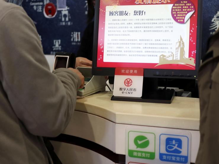 A sign of China’s digital yuan is seen above Wechat Pay