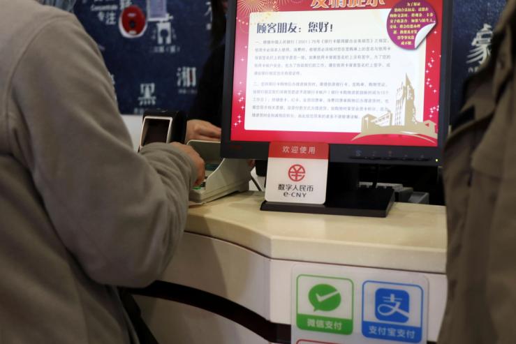 A sign of China’s digital yuan is seen above Wechat Pay