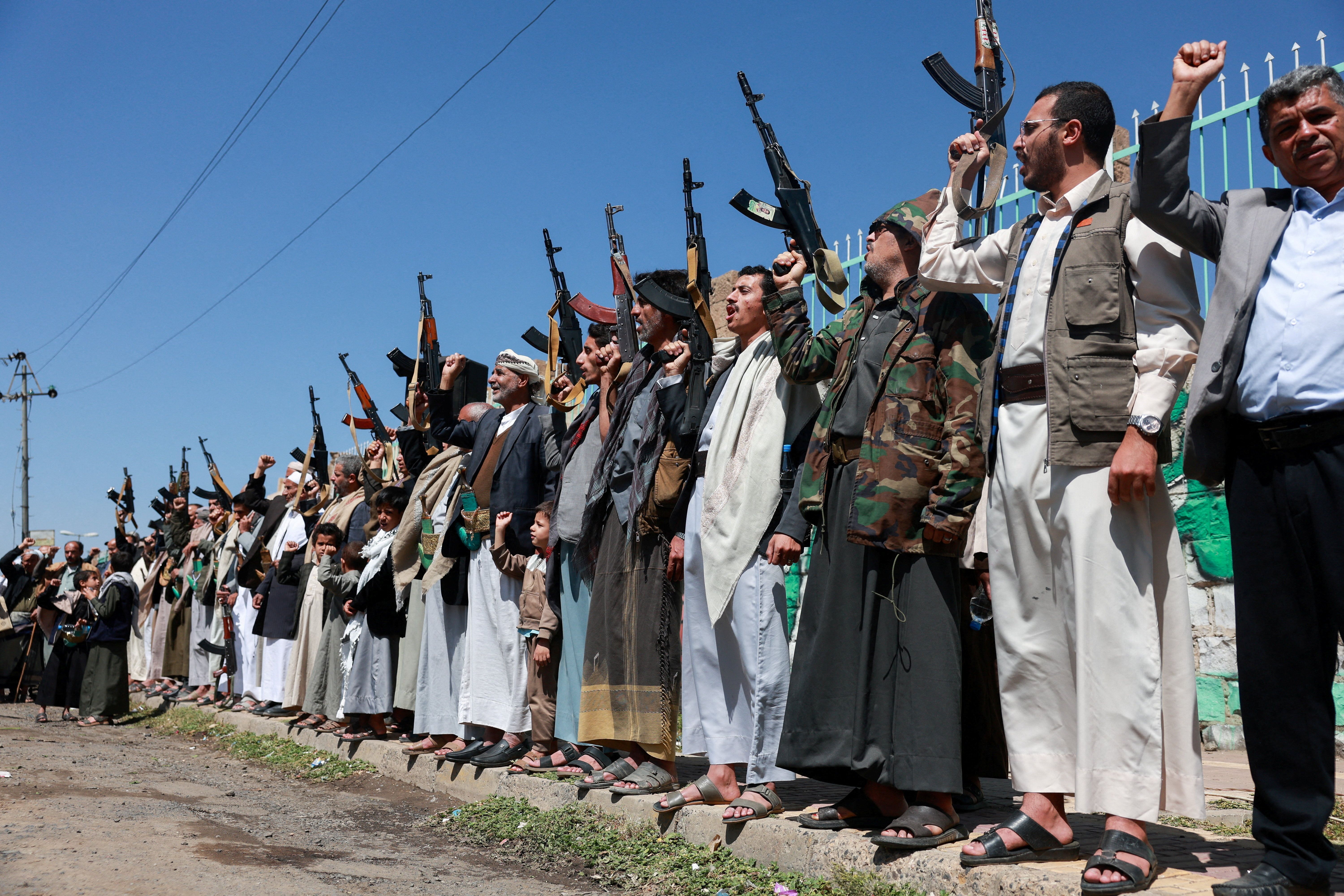 Houthi supporters carry weapons