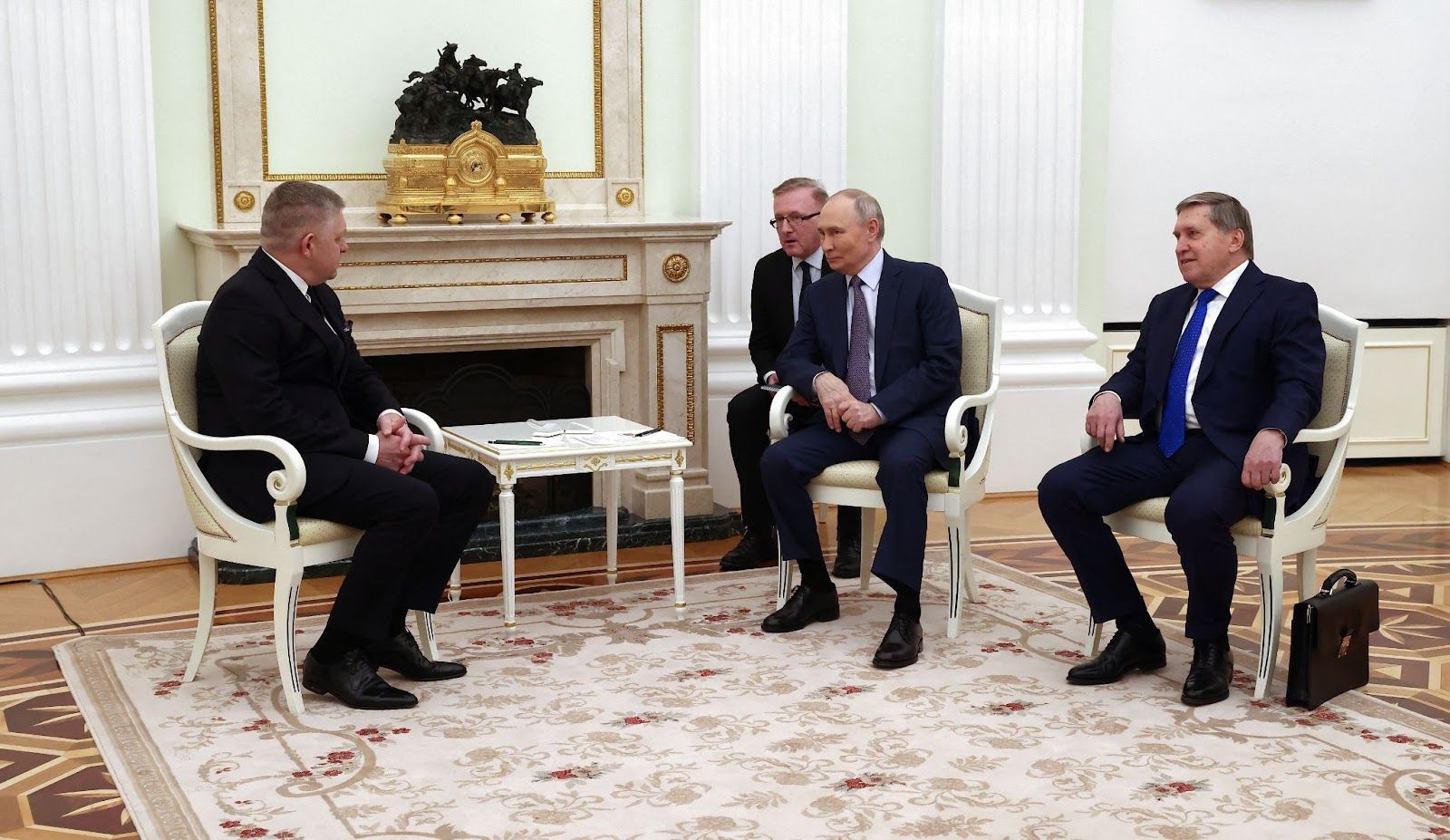 Vladimir Putin and his aide meet Robert Fico in Moscow