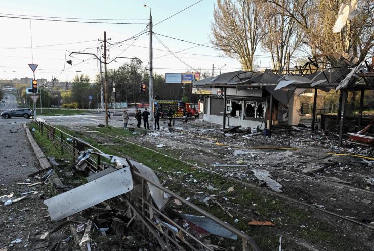 Firefighters work at the site of a Russian combined military strike.