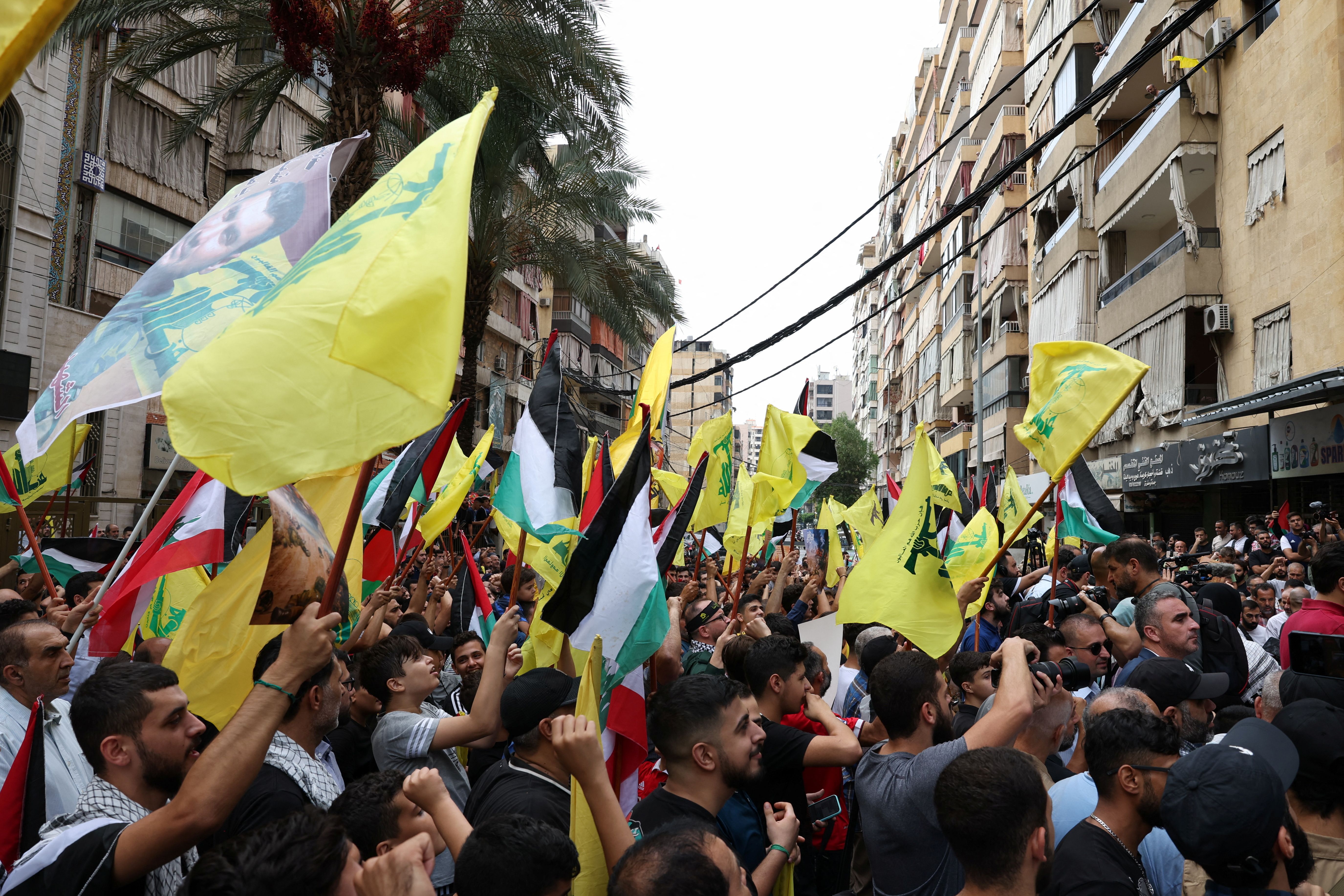 Supporters of Lebanon’s Hezbollah carry flags during a rally to express solidarity with the Palestinians in Beirut’s southern suburbs.