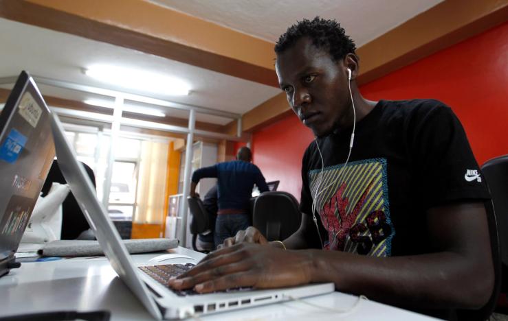Duncan Onyango, a game design developer on his laptop.
