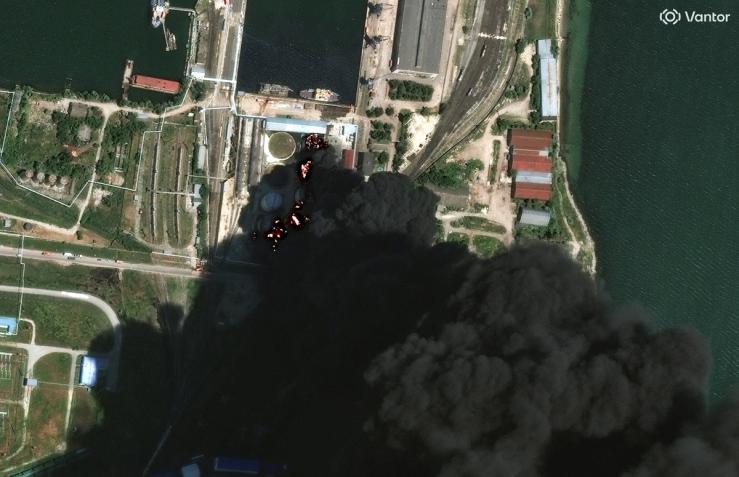 A satellite image shows fire and smoke rising from oil tanks in Crimea