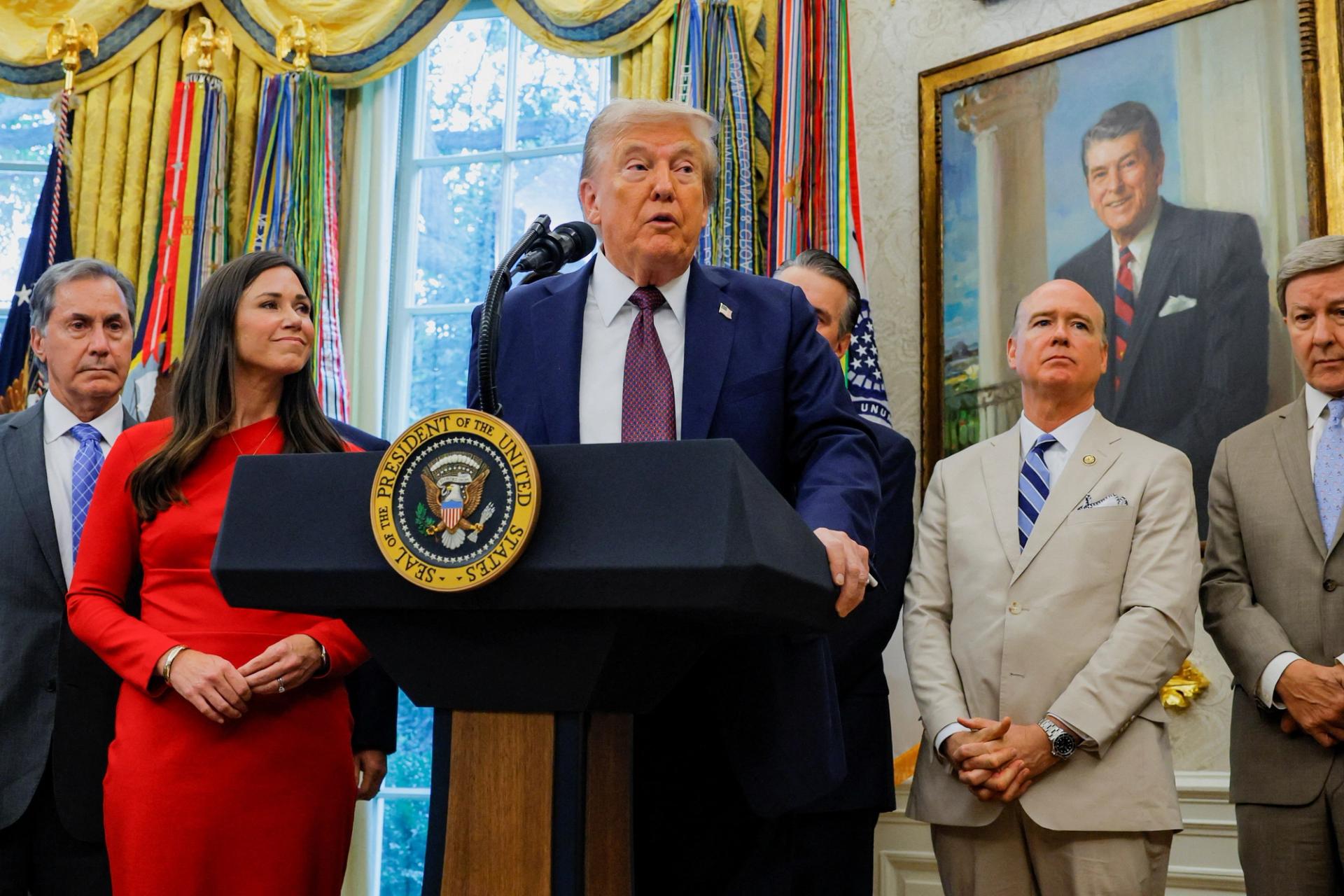 US President Donald Trump, flanked by Representative Gary Palmer (R-AL), Senator Katie Britt (R-AL), Representative Robert Aderholt (R-AL) and Representative Mike Rogers (R-AL) speaks during an event to announce that the Space Force Command will move from Colorado to Alabama, in the Oval Office at the White House.