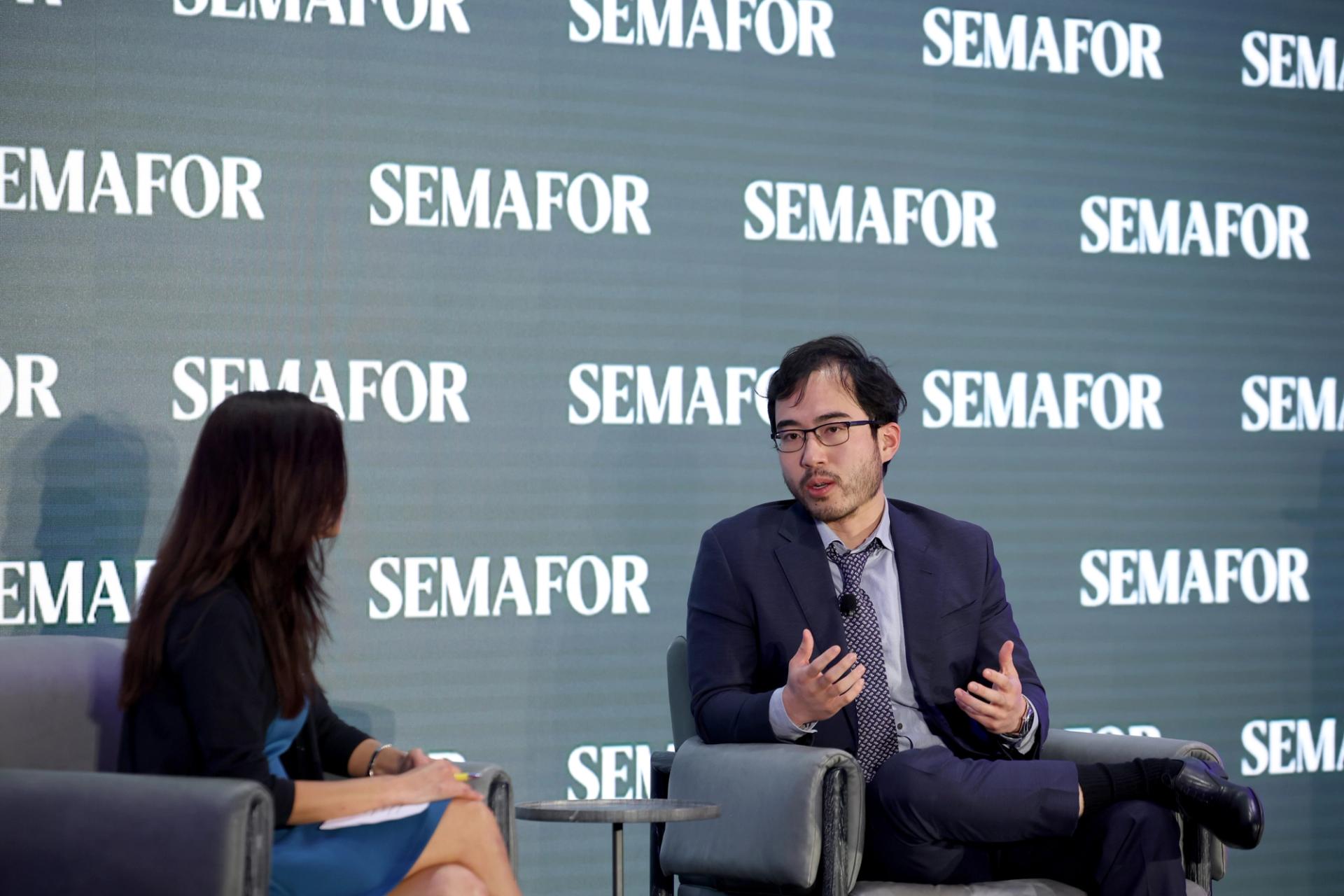 Kevin Guo speaking with Gina Chon in Washington DC.