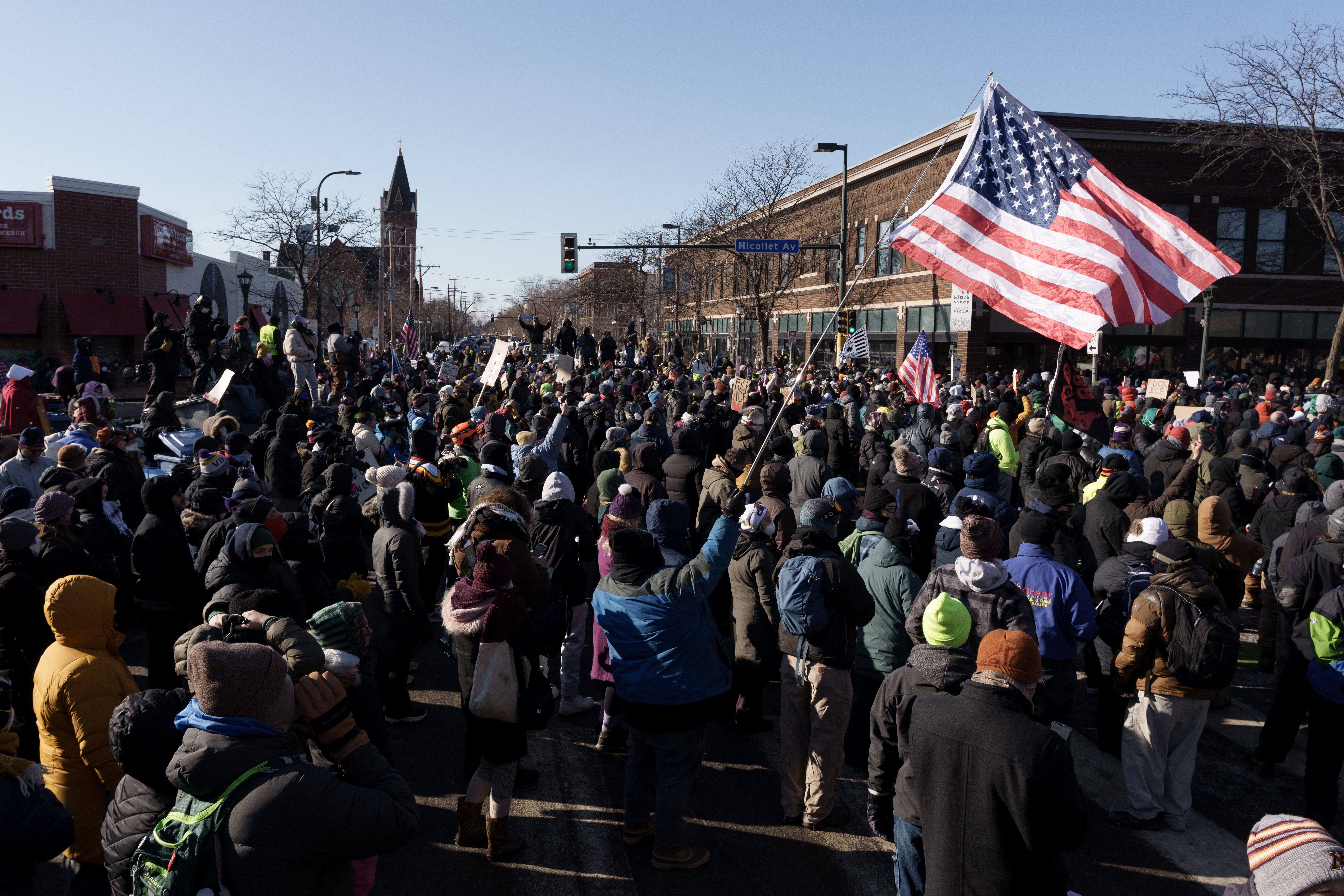 Demonstrators gather at the intersection of Nicollet Avenue and W 26th Street near the site where a man identified as Alex Pretti was fatally shot by federal agents trying to detain him, in Minneapolis.