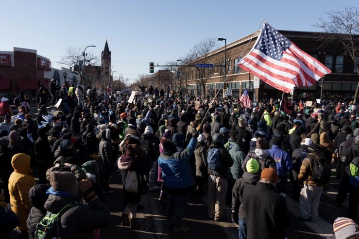 Demonstrators gather at the intersection of Nicollet Avenue and W 26th Street near the site where a man identified as Alex Pretti was fatally shot by federal agents trying to detain him, in Minneapolis.