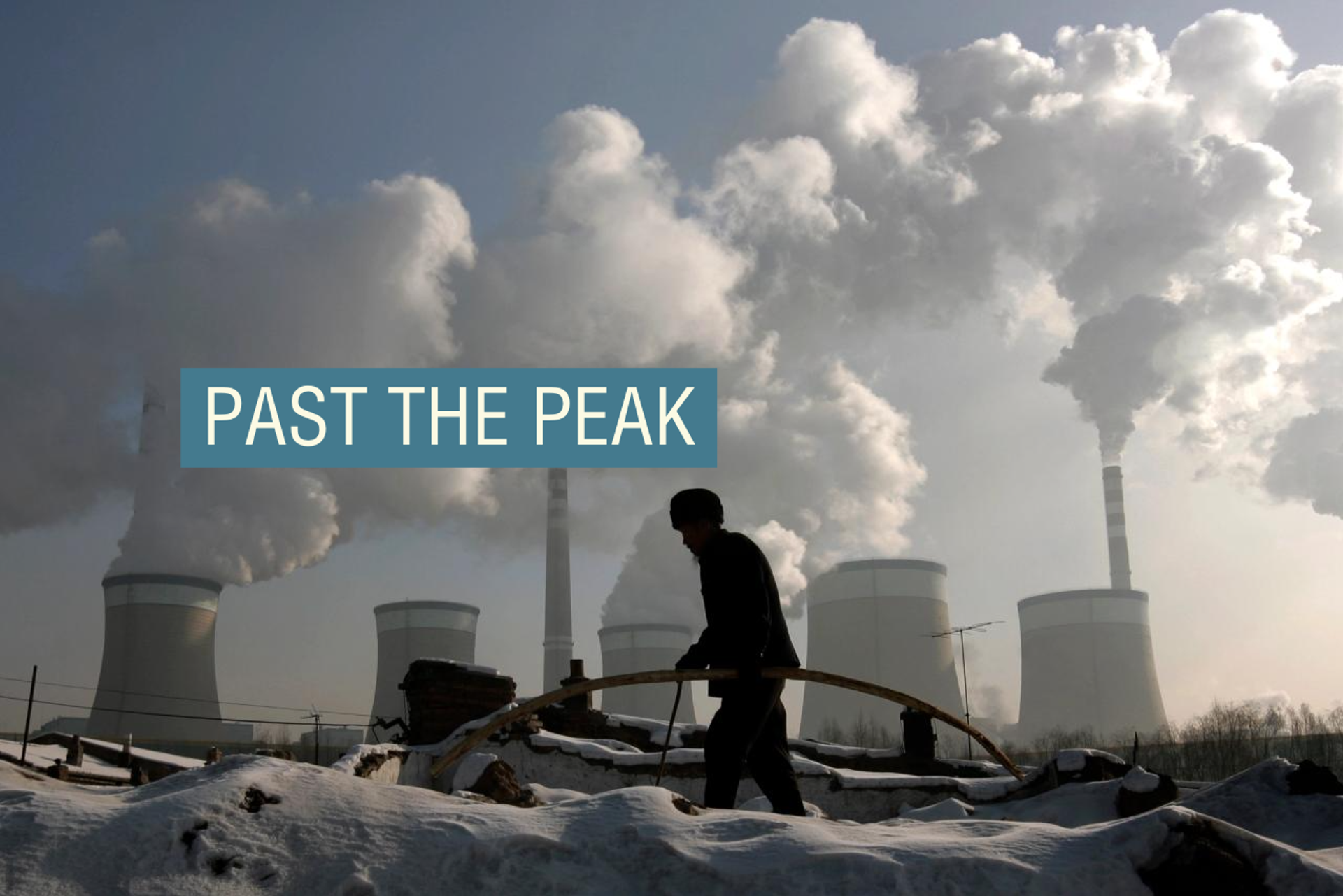 A villager walks in front of a coal-fired power plant on the outskirts of Datong, Shanxi province.