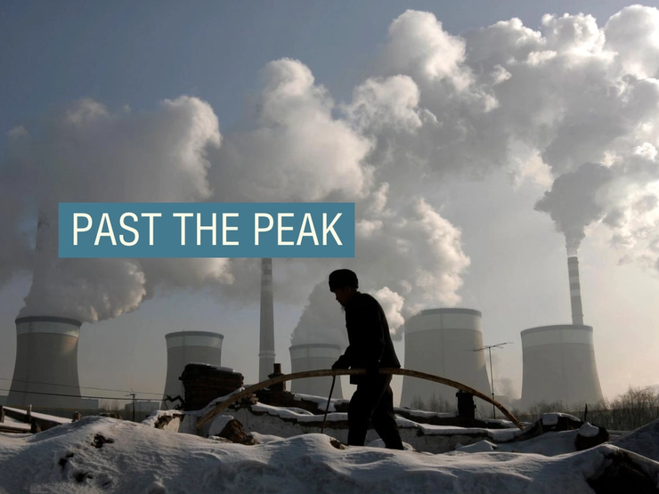 A villager walks in front of a coal-fired power plant on the outskirts of Datong, Shanxi province.