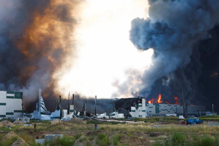 A Ukrainian warehouse engulfed in smoke after a Russian attack