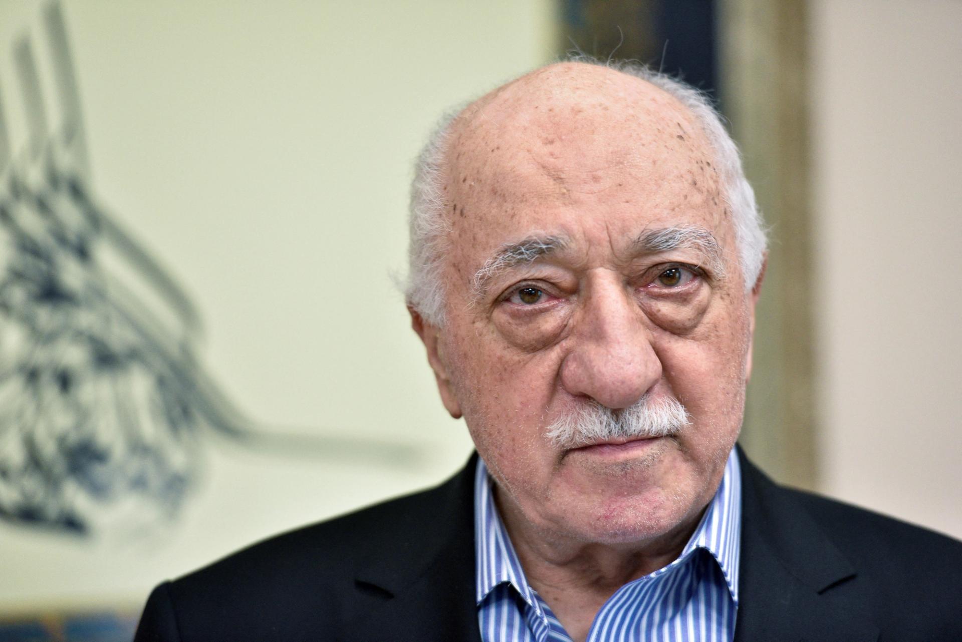 A headshot of Fethullah Gulen, wearing a dark suit and striped shirt, at his home in Pennsylvania