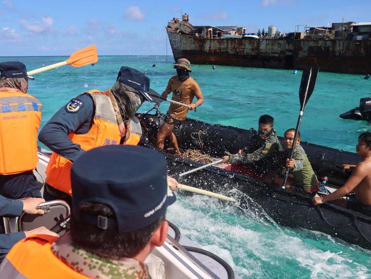 Philippine Navy personnel and China Coast Guard personnel clash near a grounded Philippine warship at Second Thomas Shoal.