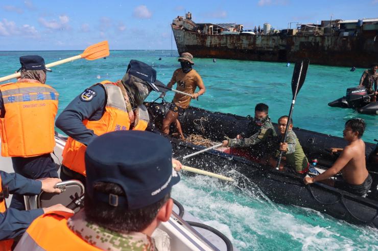Philippine Navy personnel and China Coast Guard personnel clash near a grounded Philippine warship at Second Thomas Shoal.