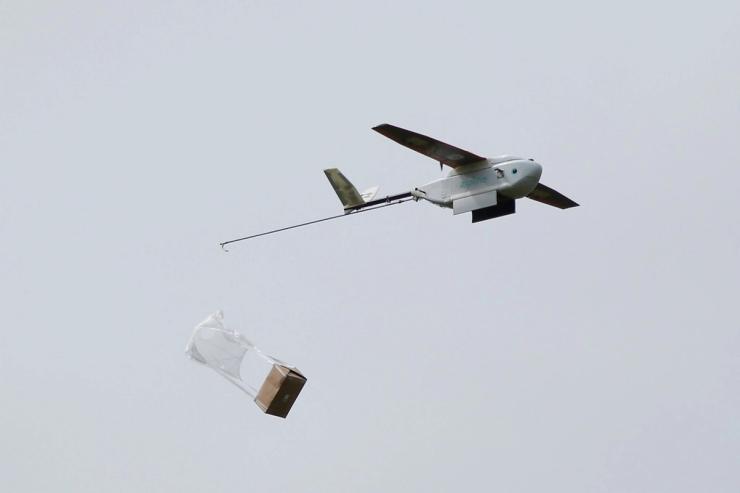A Zipline delivery drone releases its payload mid