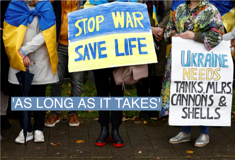 People hold posters as they take part in a protest against Russia’s military operation in Ukraine during a NATO defence ministers meeting at the Alliance’s headquarters, in Brussels, Belgium October 13, 2022.