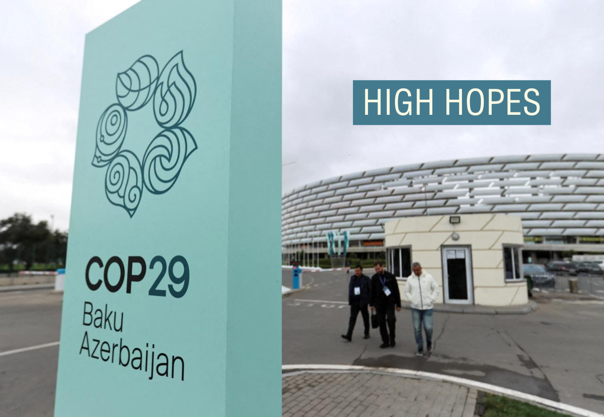 People walk near the Baku Olympic Stadium, the venue of the COP29 United Nations Climate Change Conference, in Baku, Azerbaijan.