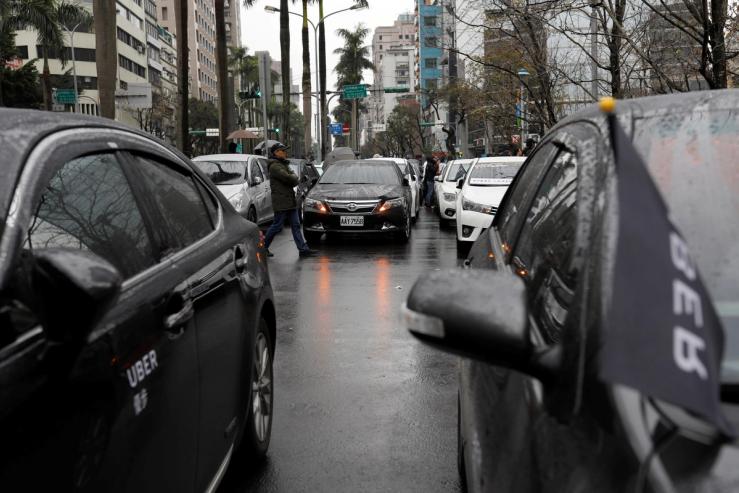 Uber drivers park their cars during a protest outside the Ministry of Transportation building in Taipei.
