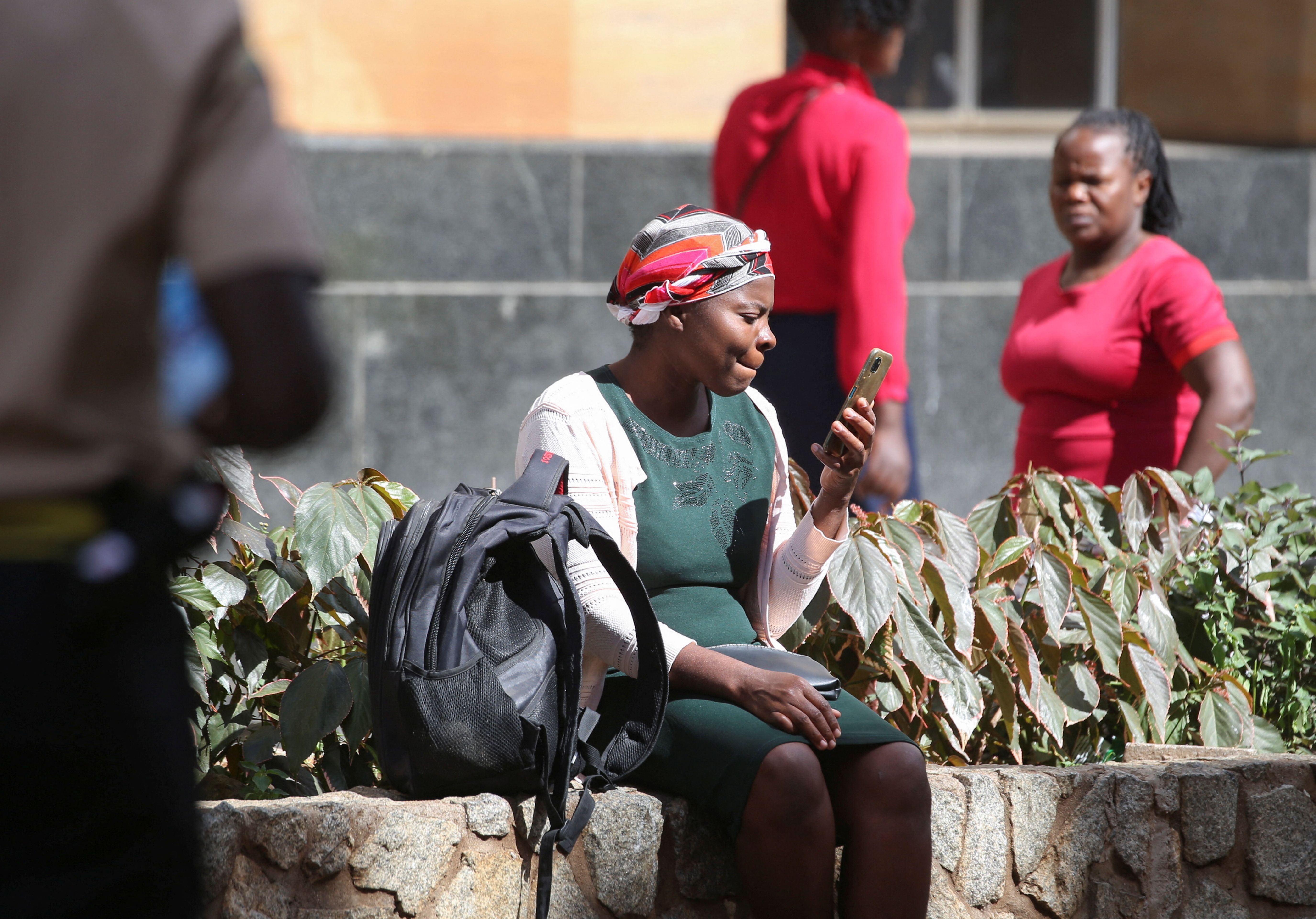 A woman looks at her mobile phone in Harare, Zimbabwe.