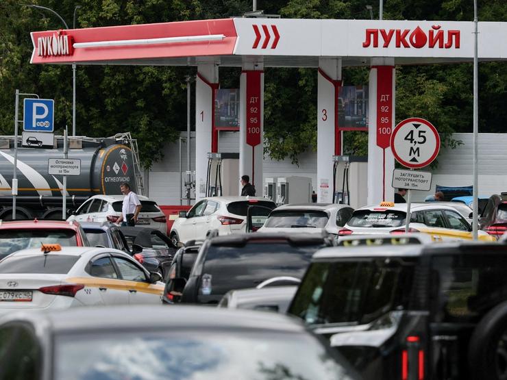 Cars queue to refuel at Lukoil fuel station in Russia.