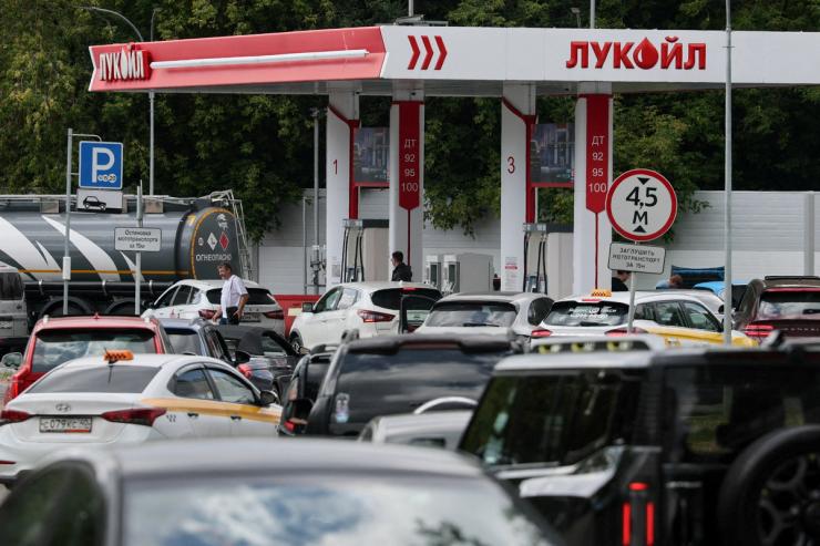 Cars queue to refuel at Lukoil fuel station in Russia.