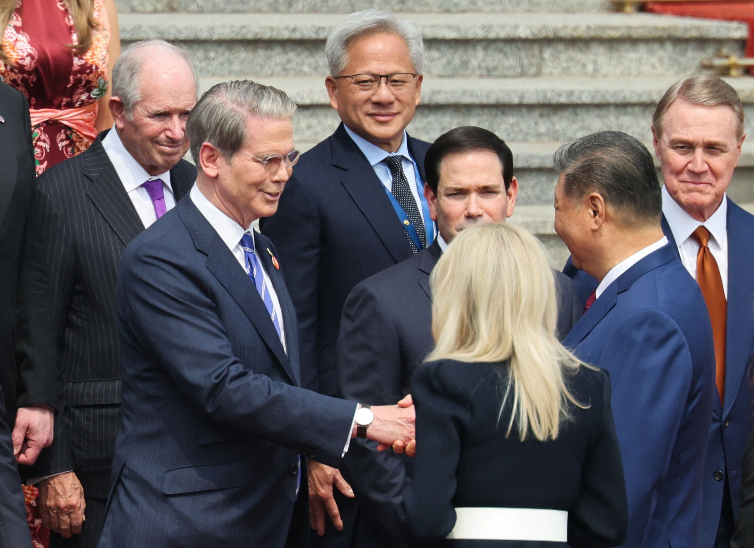 Chinese President Xi Jinping greets U.S. Treasury Secretary Scott Bessent near U.S. Secretary of State Marco Rubio, U.S. Ambassador to China David Perdue, Nvidia CEO Jensen Huang and Blackstone CEO Stephen Schwarzman at the welcome ceremony for U.S. President Donald Trump, at the Great Hall of the People in Beijing, China May 14, 2026.