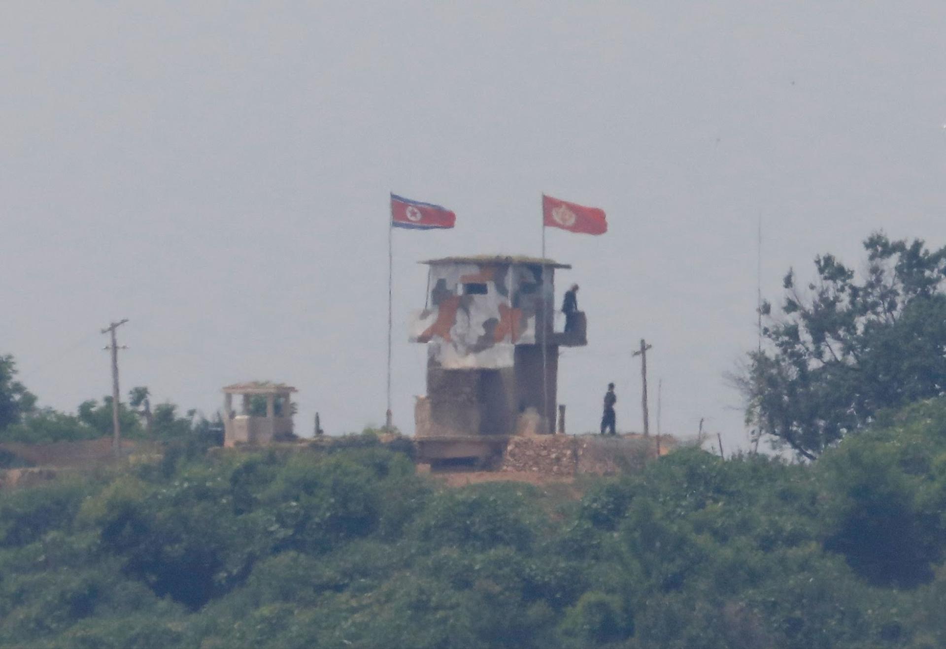 North Korean soldiers are seen at their guard post from Paju city in South Korea. 