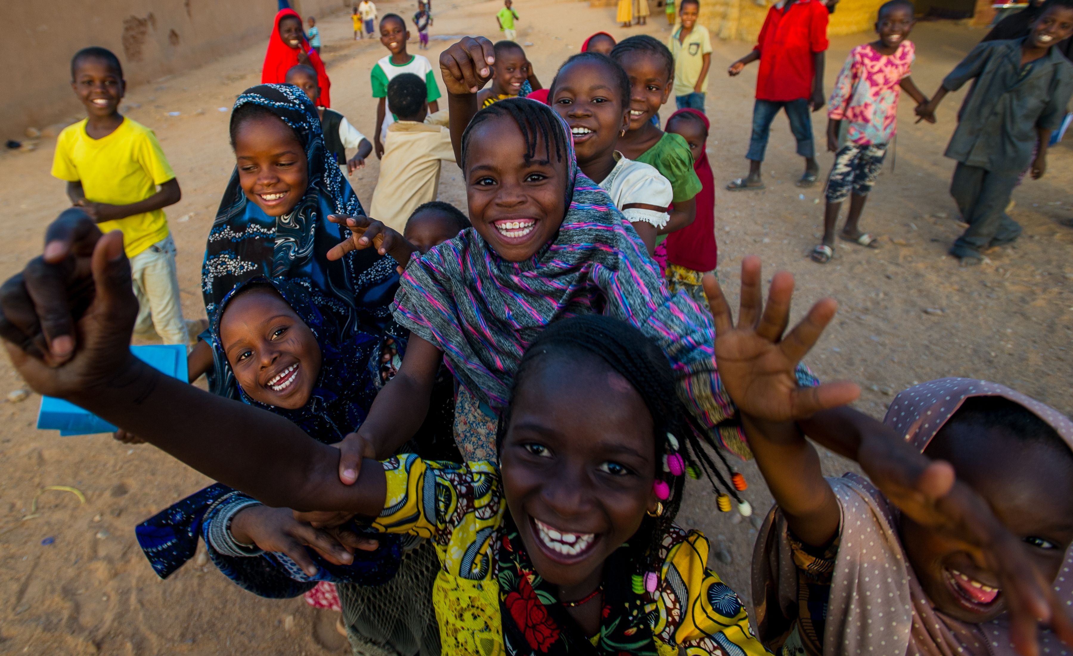 School children in Niger react playfully to the sight of a camera on the street.