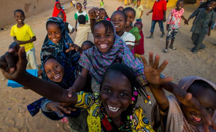 School children in Niger react playfully to the sight of a camera on the street.