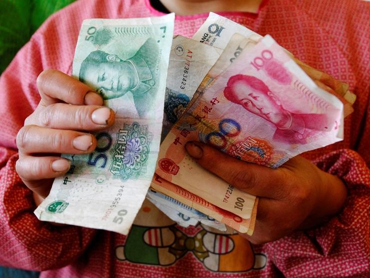 A vendor counts yuan banknotes.
