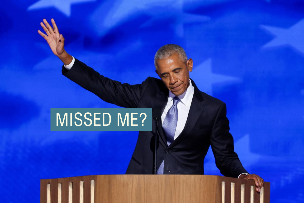 Barack Obama, in a dark suit and light tie, raises his hand dramatically while addressing the Democratic National Convention.