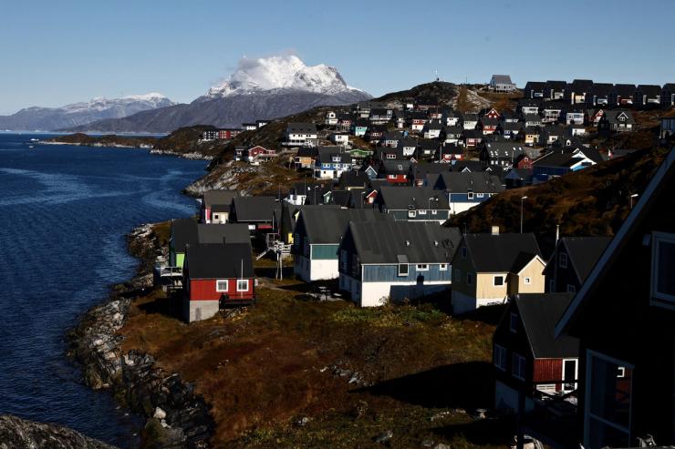 Houses stand in front of the mountain Sermitsiaq, in Nuuk, Greenland.