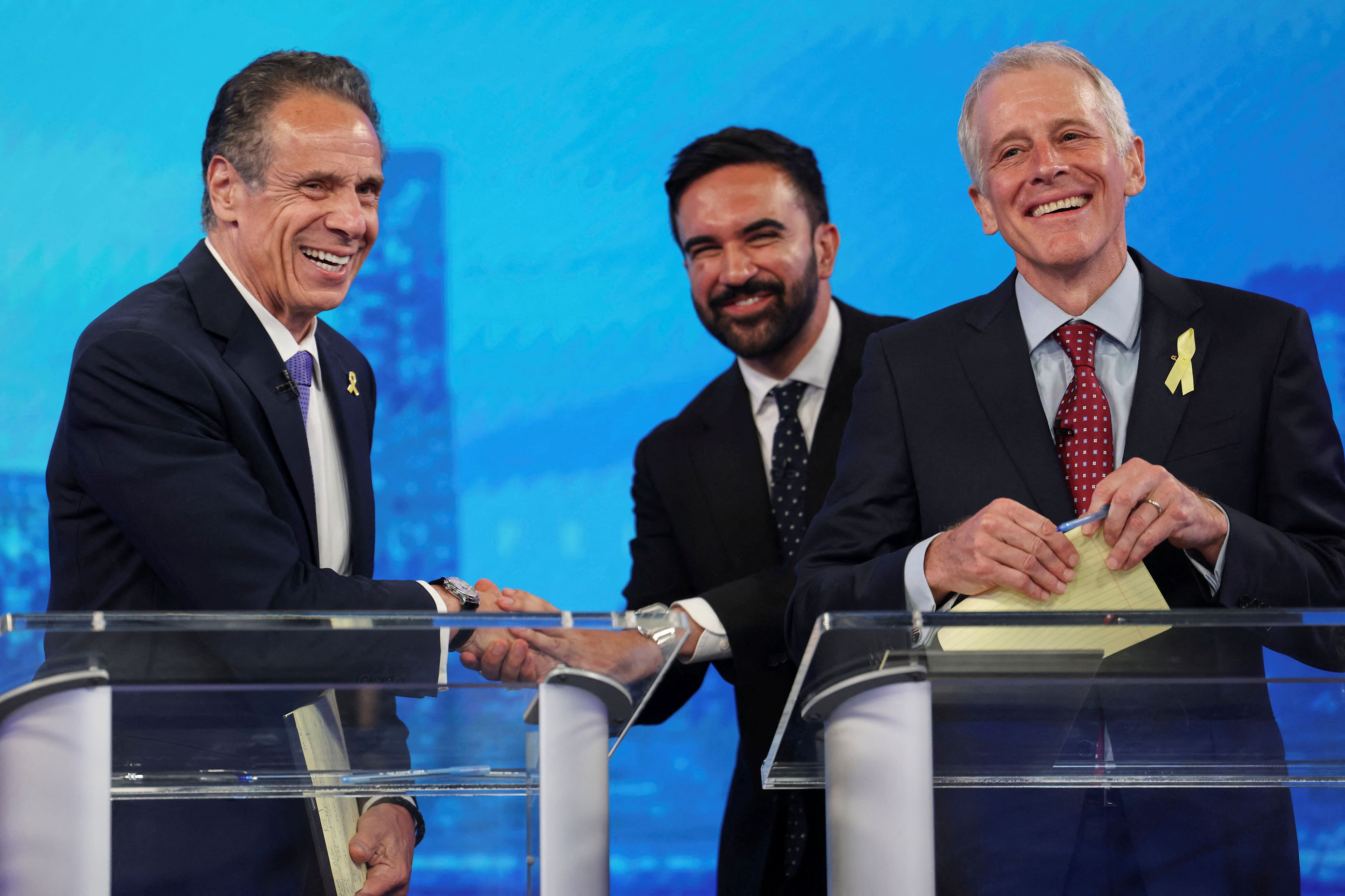 Mayoral candidates Zohran Mamdani and Andrew Cuomo shake hands.