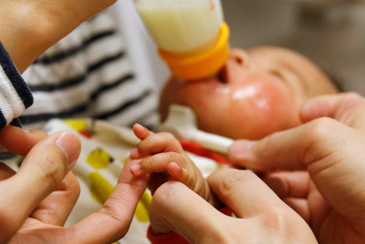 Kosuke Mori, a three-month-old baby, is fed by his mother.