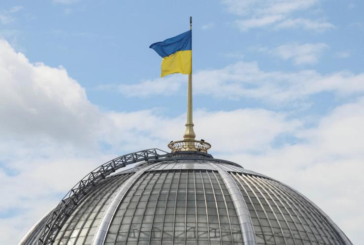 A Ukrainian flag flies over the parliament building.
