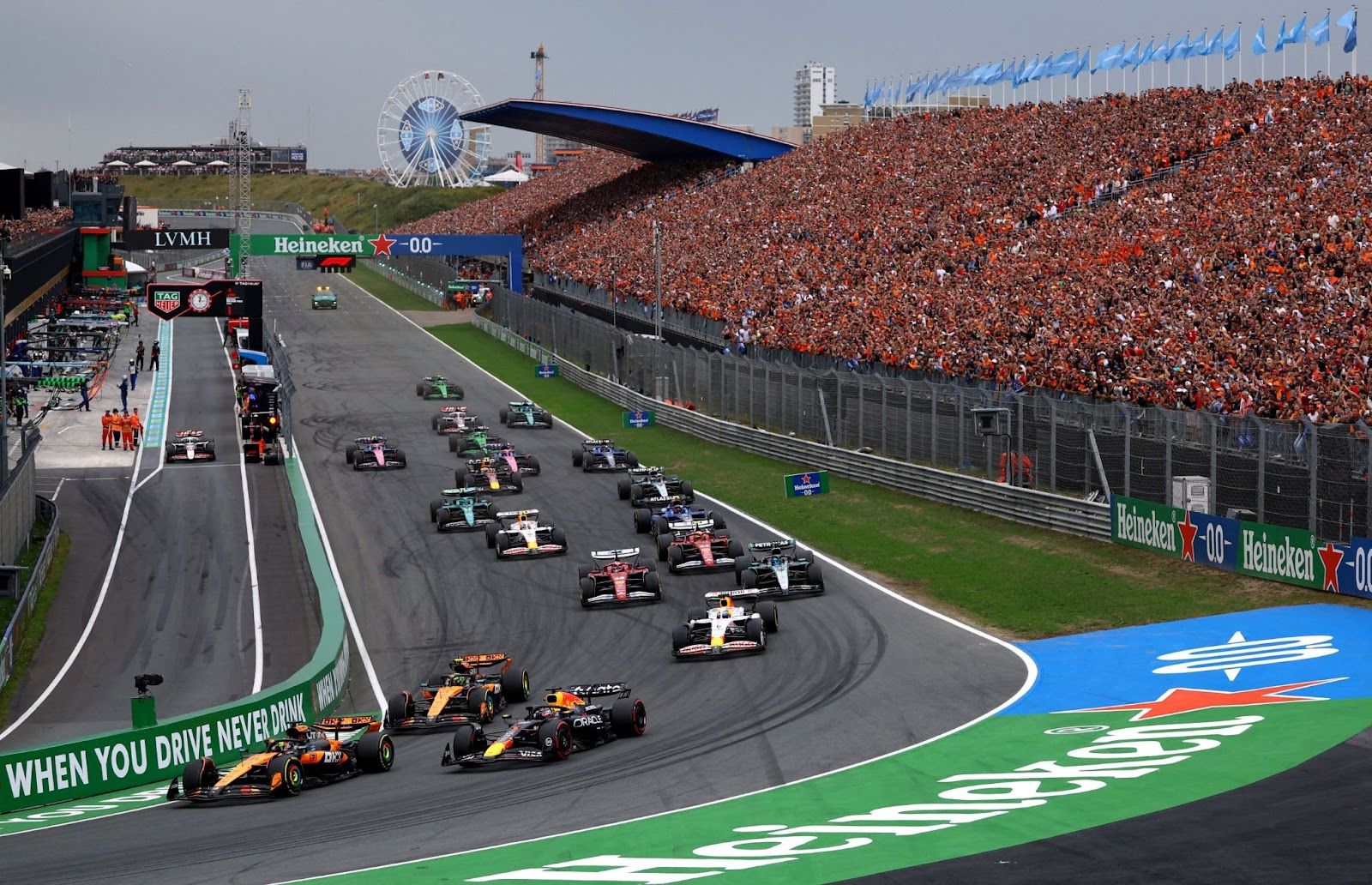 McLaren’s Oscar Piastri leads into the first corner at the start of the race ahead of McLaren’s Lando Norris and Red Bull’s Max Verstappen.