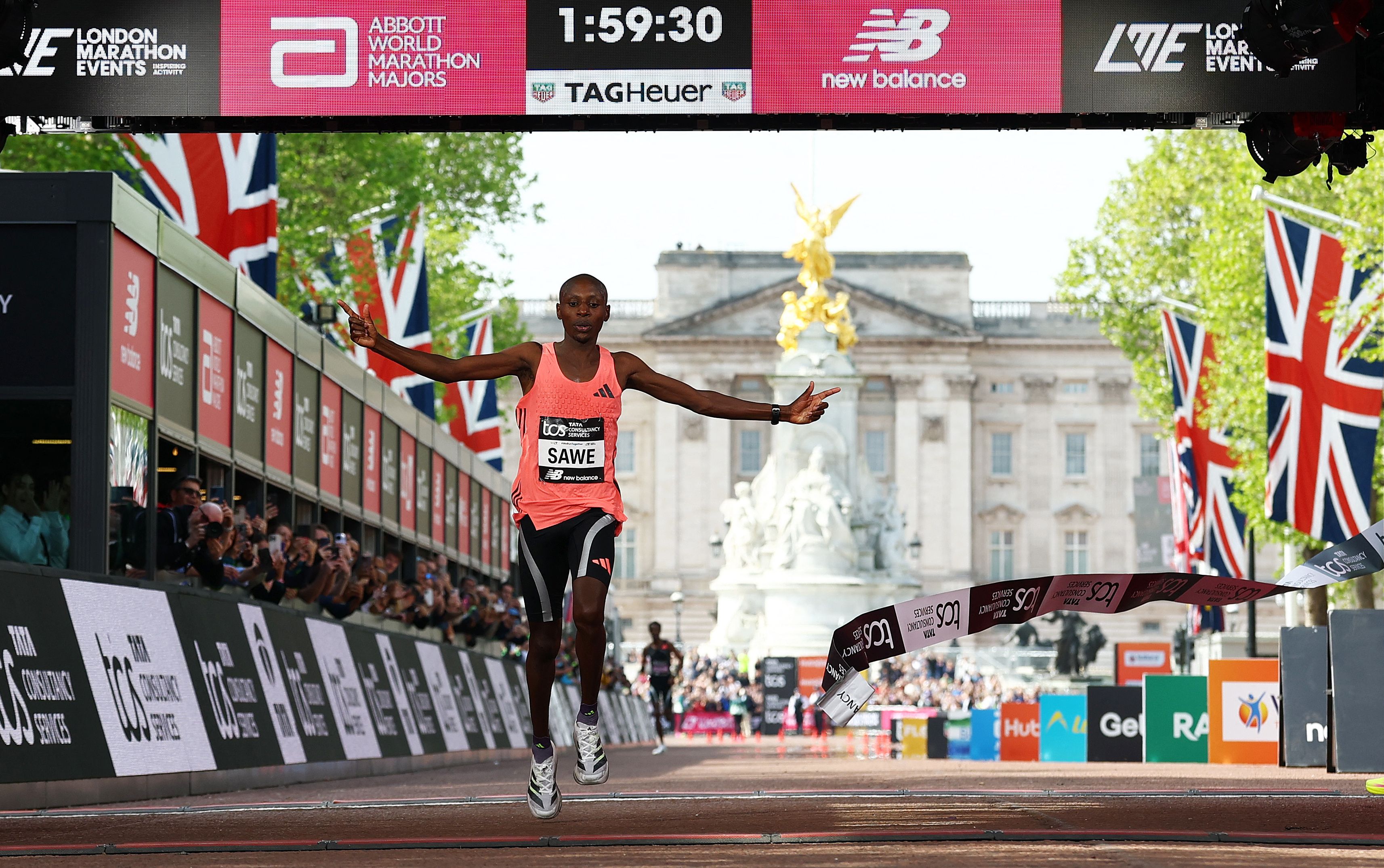 Kenya’s Sabastian Sawe crosses the finish line to win the men’s elite race in the London Marathon