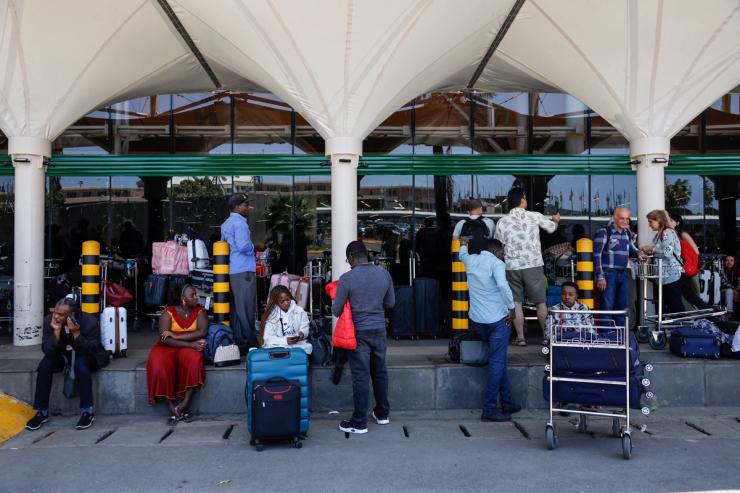 Passengers wait at a closed door at the departures of the Jomo Kenyatta International Airport in Nairobi.
