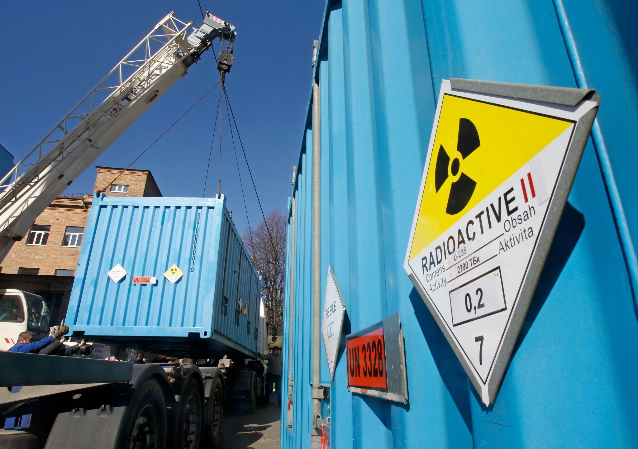 Workers place a container with spent highly-enriched uranium on a truck in Kyiv in 2012.