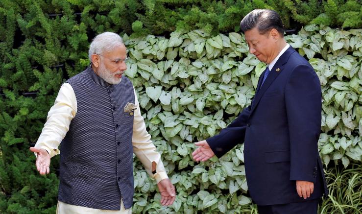 Indian Prime Minister Narendra Modi and Chinese leader Xi Jinping greet one another.