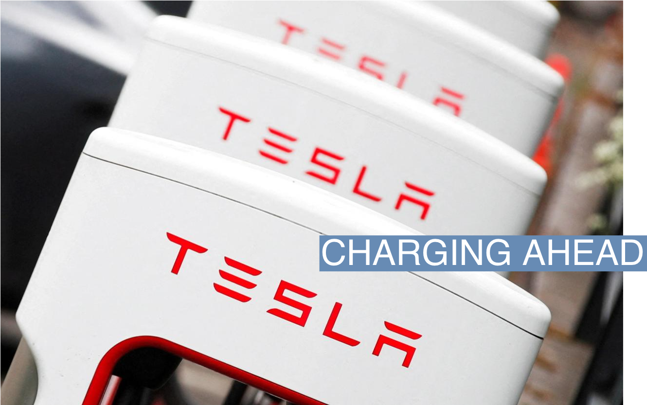 The logo of car manufacturer Tesla is seen at a dealership in London, Britain, May 14, 2021. REUTERS/Matthew Childs/File Photo