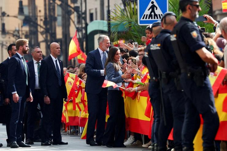 Spain’s King and Queen greet people as they arrive in Ceuta.