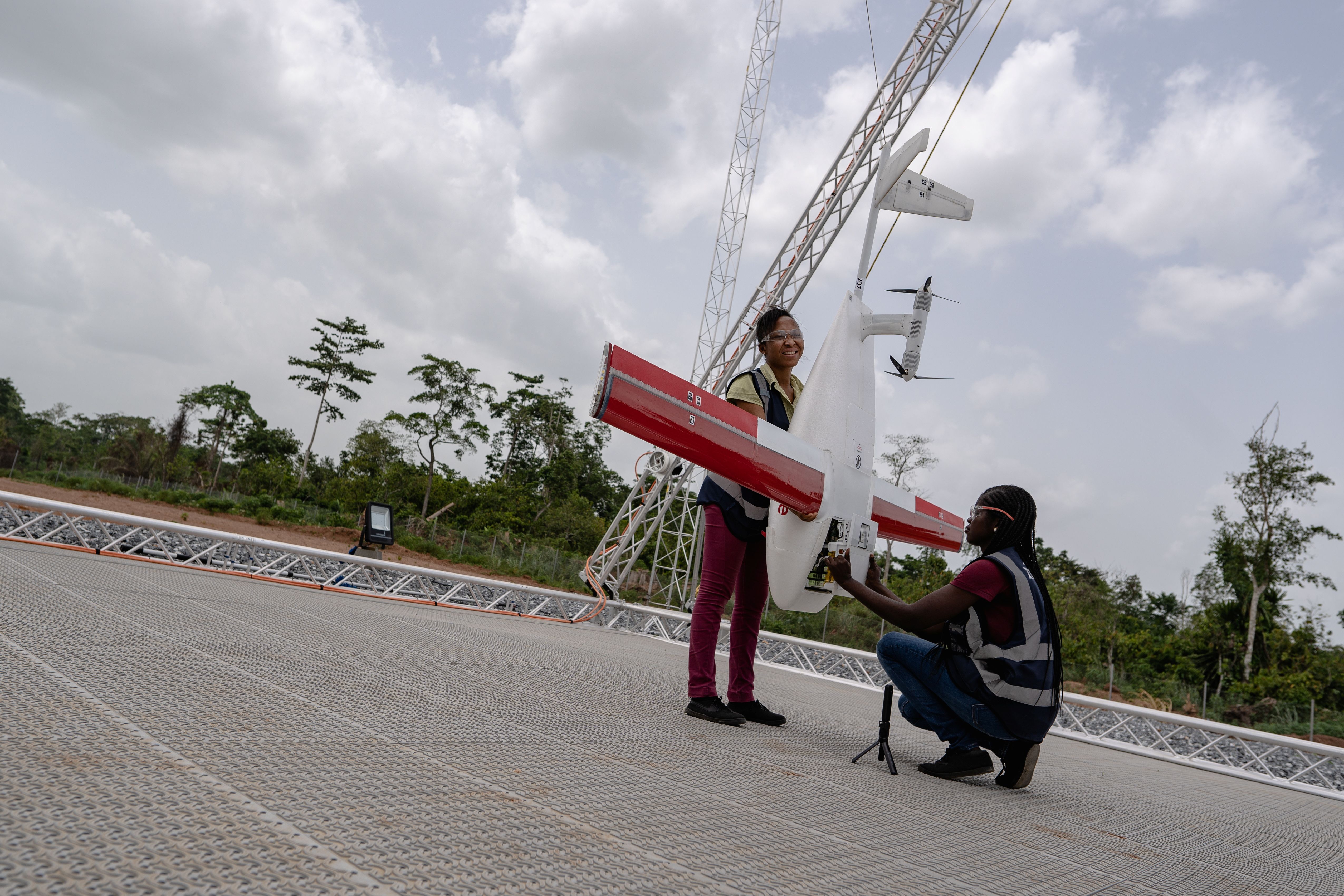 Workers pack a box of vaccines to be delivered by a Zipline drone, in Ghana.