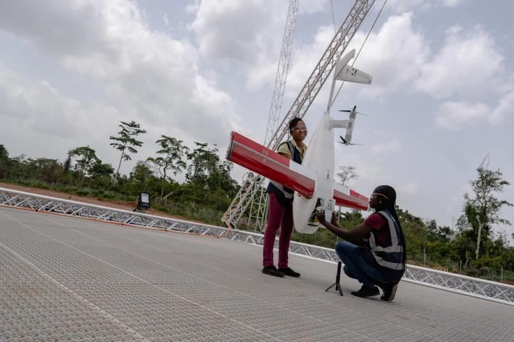 Workers pack a box of vaccines to be delivered by a Zipline drone, in Ghana.