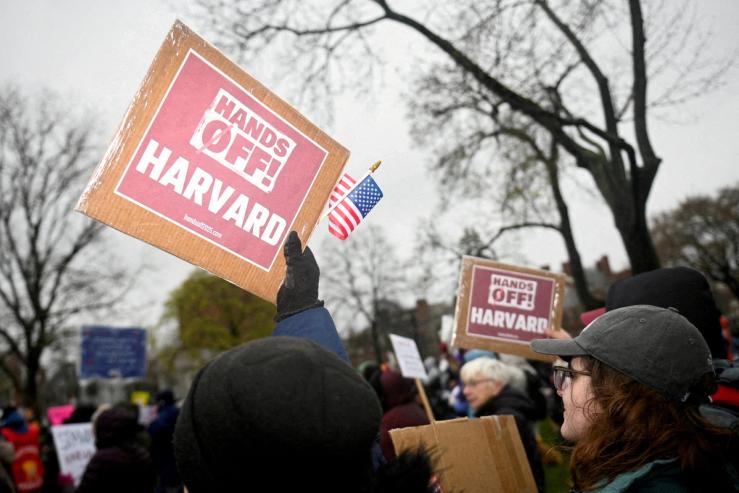 Demonstrators rally on Cambridge Common in a protest organized by the City of Cambridge calling on Harvard leadership to resist interference at the university by the federal government in Cambridge, Massachusetts.