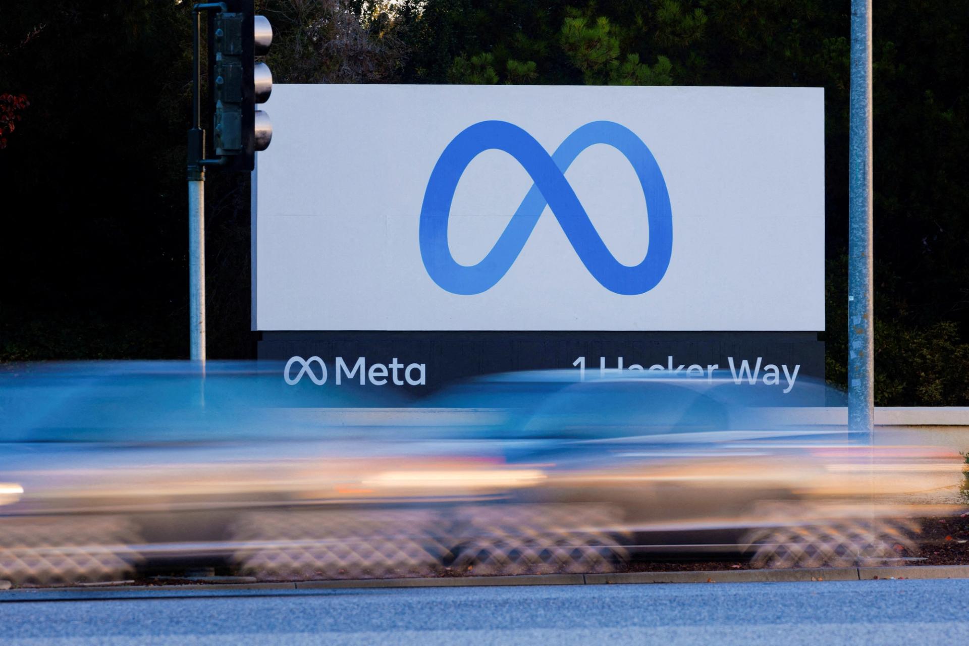 Morning commute traffic streams past the Meta sign.
